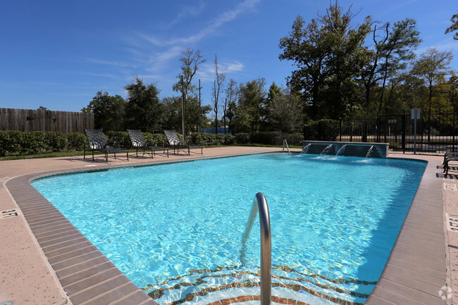 Sparkling pool with sundeck and waterfall - Woodside Manor Rental