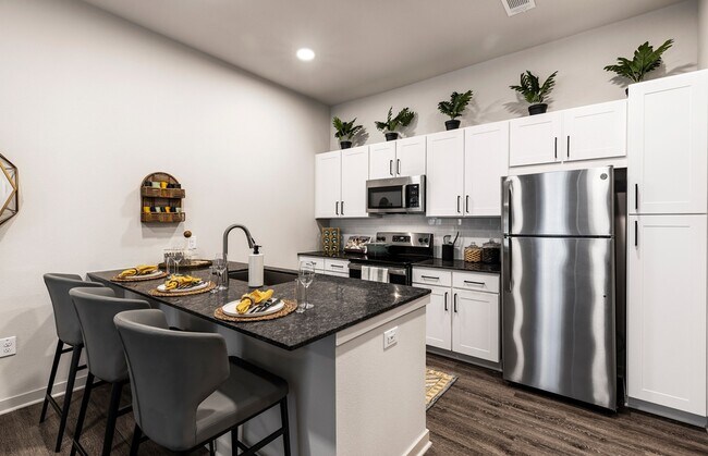 Gourmet Kitchens with Granite Counter Tops - Overture River District 55+ Active Adult A... Apartments